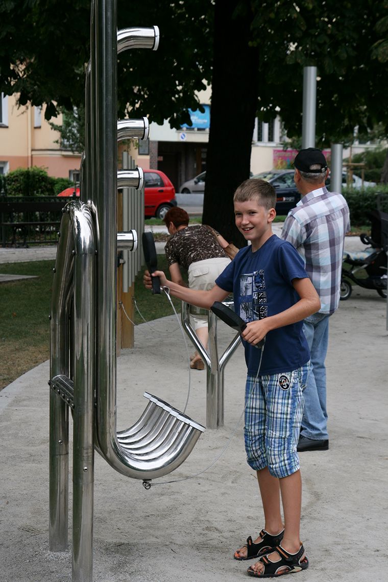 Teenage Boy Playing Stainless Steel aerophone outdoor musical instrument in park