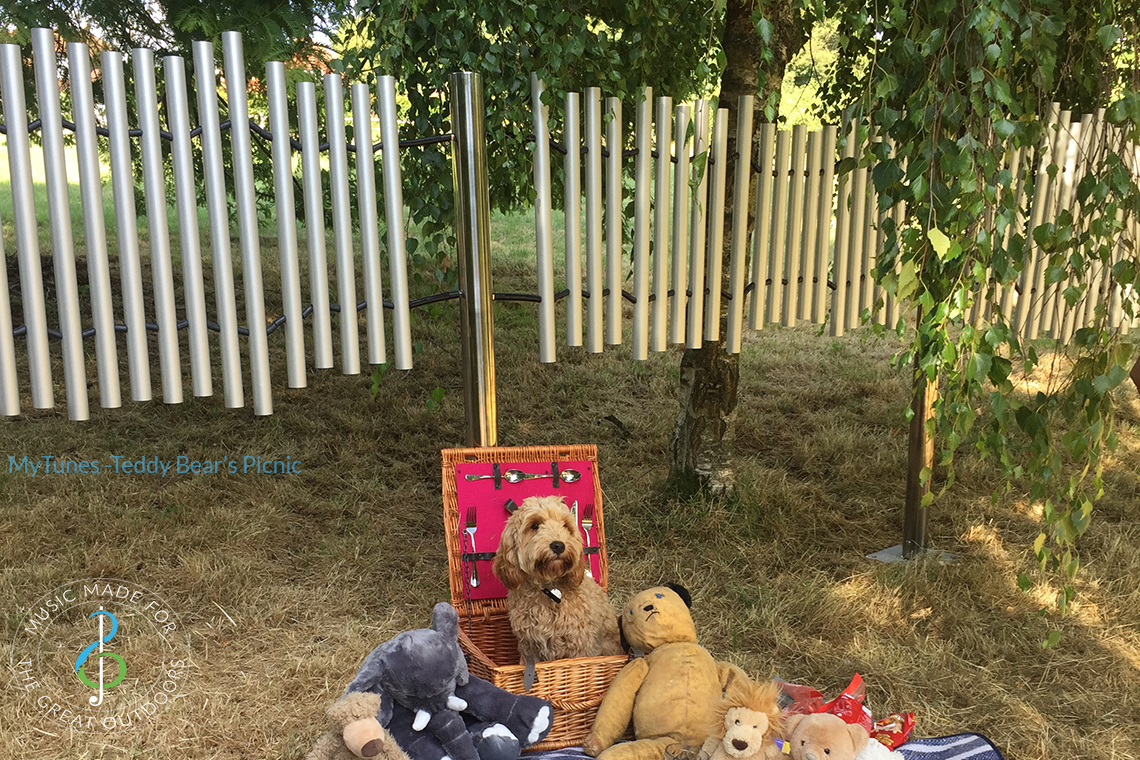 outdoor musical chime set which plays Teddy Bear Picnic with a small dog and teddy bears underneath